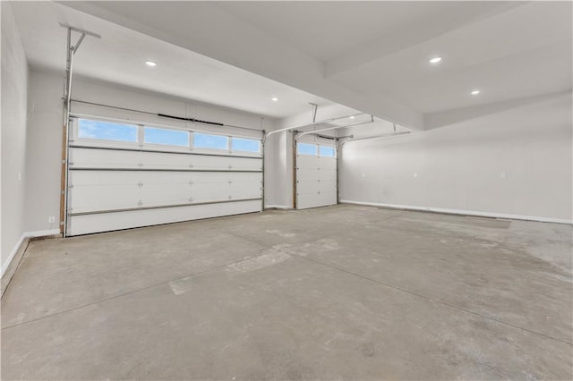 garage with recessed lighting and baseboards