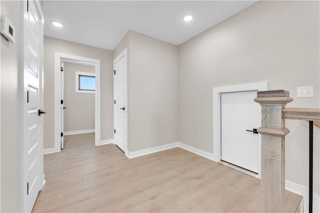 corridor with recessed lighting, light wood-type flooring, and baseboards