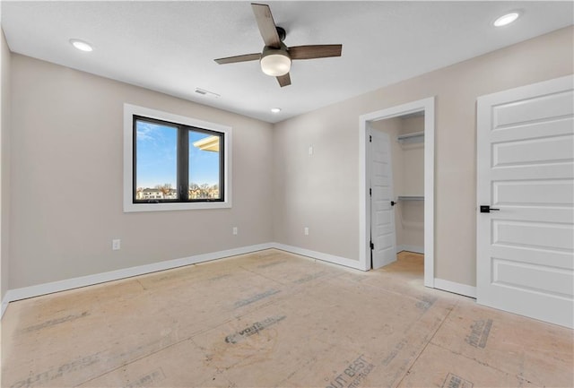 unfurnished bedroom with ceiling fan, recessed lighting, visible vents, baseboards, and a walk in closet