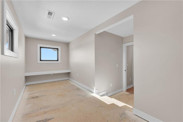 spare room featuring visible vents and baseboards