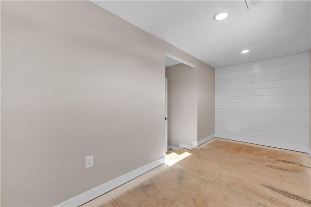 unfurnished room with baseboards and recessed lighting