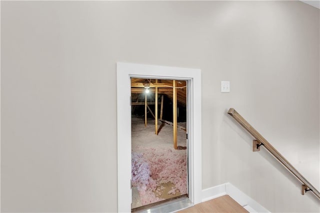 stairs featuring baseboards and wood finished floors