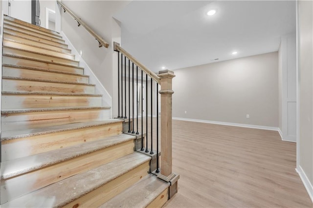 stairs featuring recessed lighting, baseboards, and wood finished floors