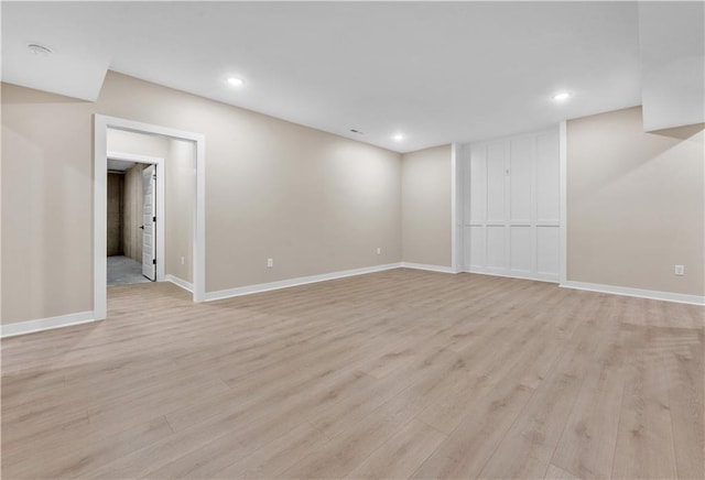 below grade area featuring baseboards, recessed lighting, and light wood-style floors