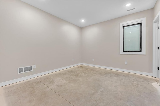 empty room featuring baseboards, visible vents, and concrete flooring