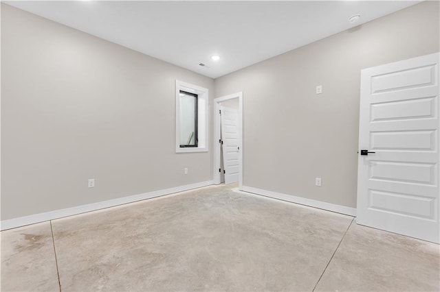 spare room featuring visible vents, concrete floors, baseboards, and recessed lighting