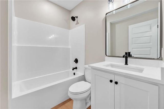 full bathroom featuring washtub / shower combination, vanity, toilet, and wood finished floors