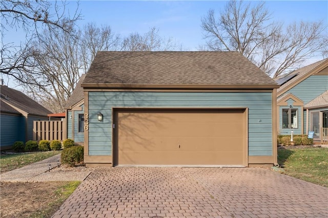 garage featuring decorative driveway