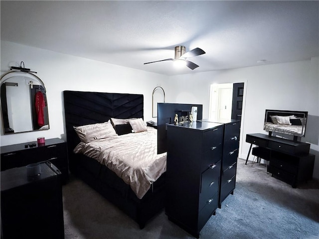 bedroom with dark colored carpet and a ceiling fan