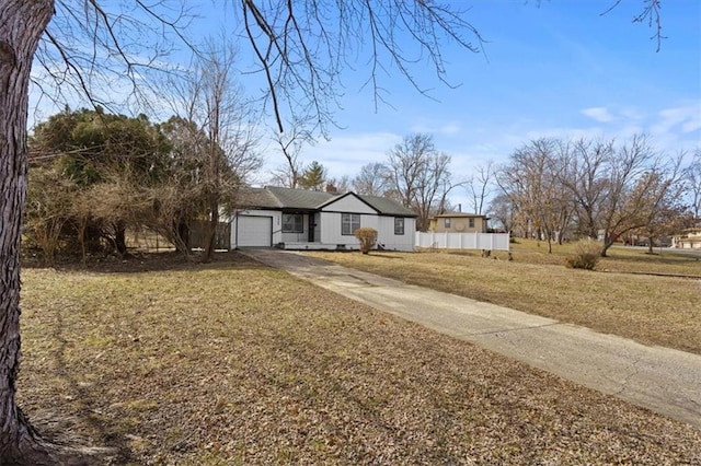 ranch-style home with an attached garage, crawl space, fence, driveway, and a front lawn