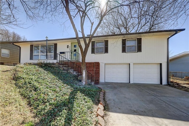 ranch-style home featuring stairway, an attached garage, and driveway