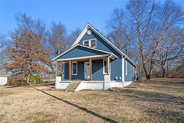 bungalow-style home featuring covered porch and a front lawn