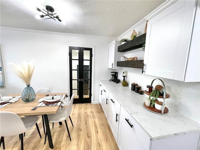 kitchen with white cabinets, french doors, light wood-type flooring, open shelves, and crown molding