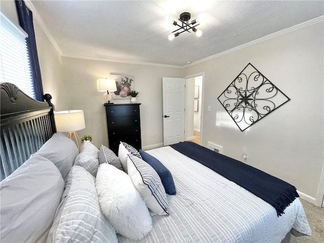 carpeted bedroom featuring baseboards and crown molding