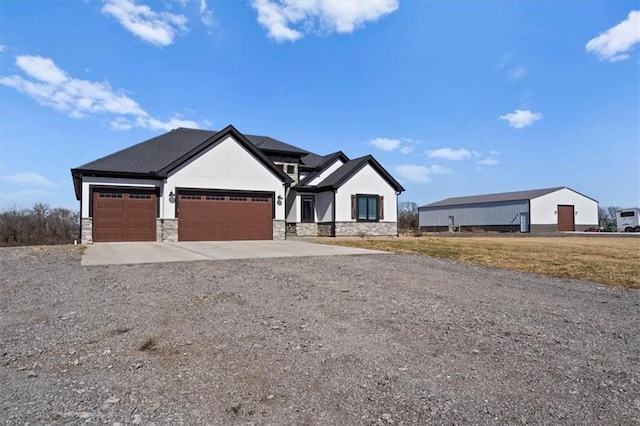 modern farmhouse style home featuring gravel driveway, stone siding, and an attached garage