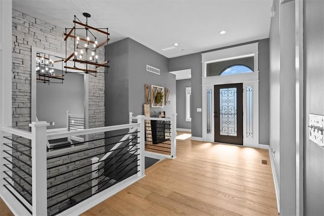 entryway with baseboards, visible vents, wood finished floors, and recessed lighting