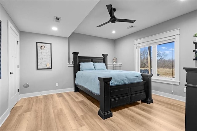 bedroom with light wood finished floors, recessed lighting, visible vents, and baseboards