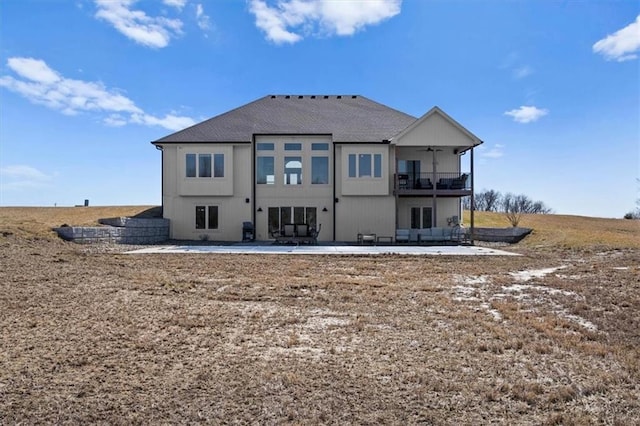 rear view of property with a patio, a balcony, and a ceiling fan