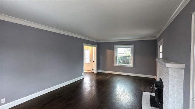 unfurnished living room with dark wood-style floors, baseboards, and crown molding