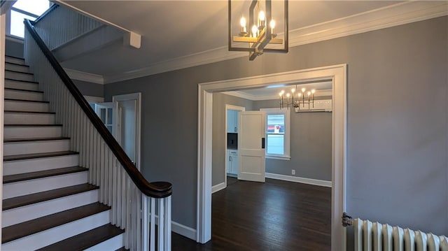 stairway featuring radiator, a notable chandelier, crown molding, and wood finished floors