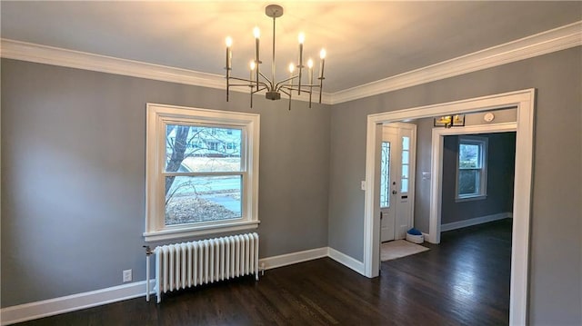 unfurnished dining area featuring radiator, baseboards, dark wood finished floors, and crown molding