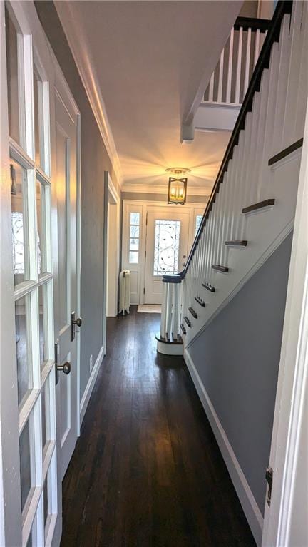 foyer entrance with dark wood-style flooring, baseboards, french doors, stairway, and radiator heating unit