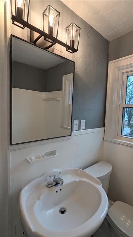 half bath with a sink and toilet