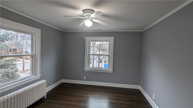 unfurnished room featuring ceiling fan, dark wood-style flooring, baseboards, ornamental molding, and radiator heating unit