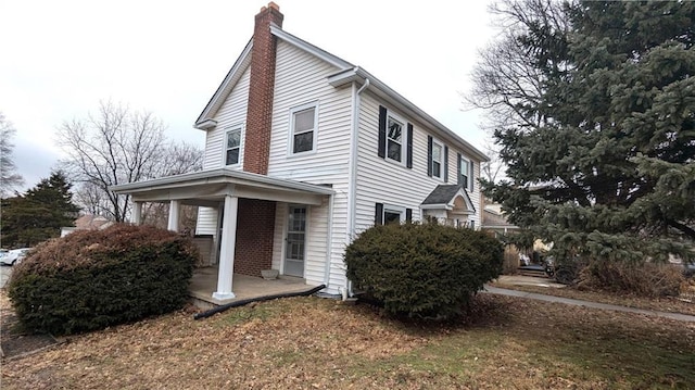 view of side of home featuring a chimney