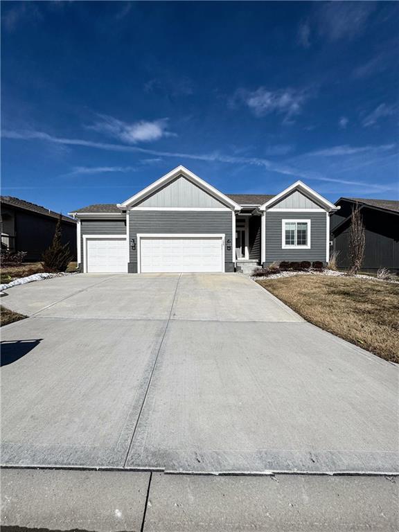 ranch-style home featuring a garage and concrete driveway