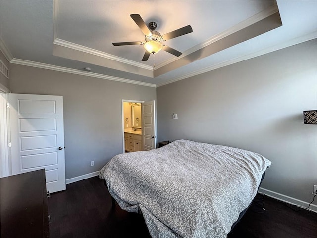 bedroom with a tray ceiling, dark wood-style flooring, crown molding, and baseboards