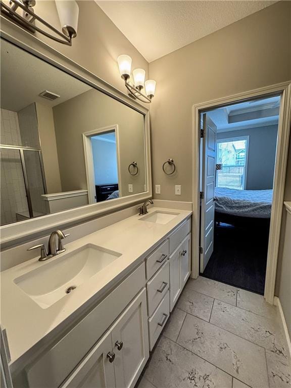 ensuite bathroom with ensuite bath, visible vents, and a sink