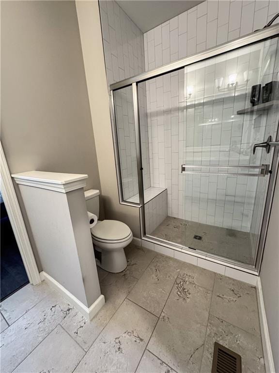 full bath featuring a stall shower, baseboards, visible vents, and toilet