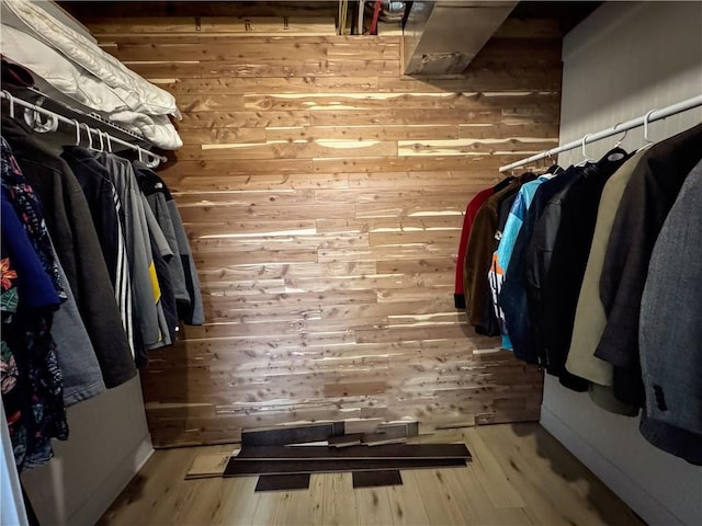 walk in closet featuring wood finished floors