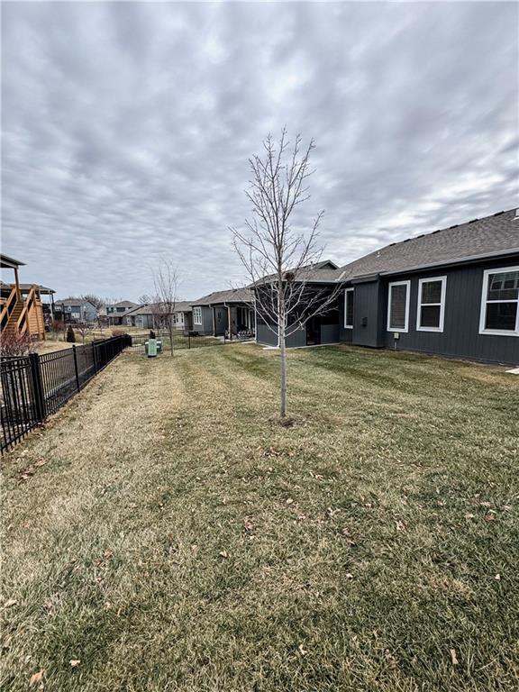 view of yard with fence and a playground