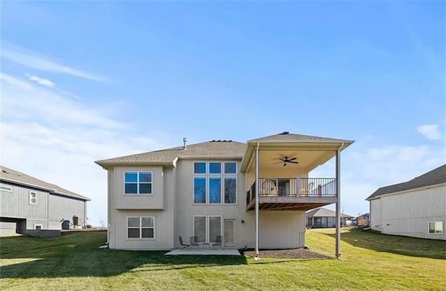 rear view of property with a patio area, a lawn, and ceiling fan