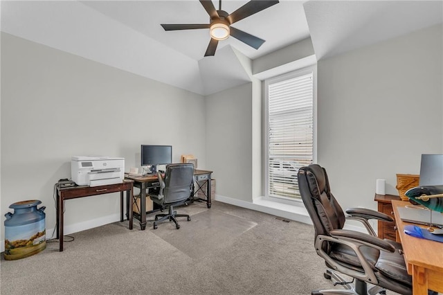 home office with lofted ceiling, carpet floors, a ceiling fan, and baseboards