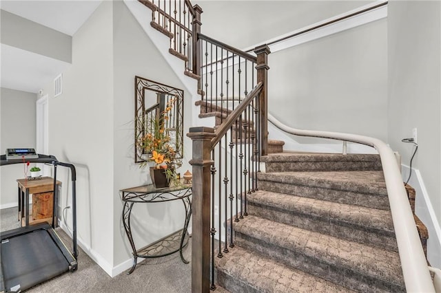 stairway featuring carpet floors and baseboards