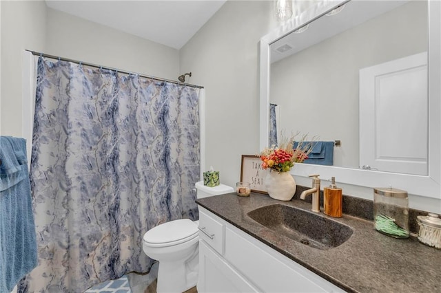 bathroom with visible vents, toilet, vanity, and a shower with curtain