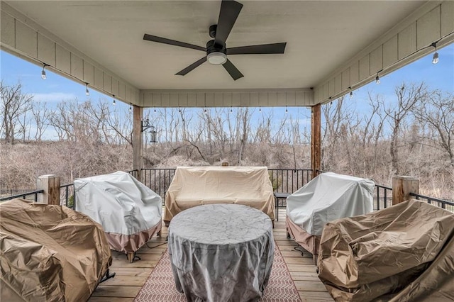 wooden terrace featuring a grill and a ceiling fan