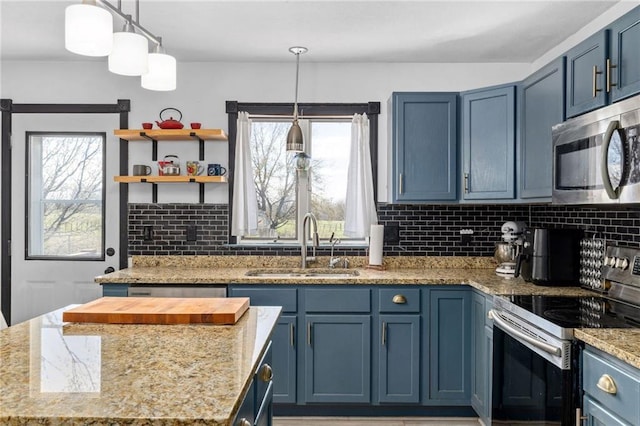 17259 174th St, Basehor, KS 66007 - kitchen with appliances with stainless steel finishes, blue cabinets, a sink, and decorative backsplash