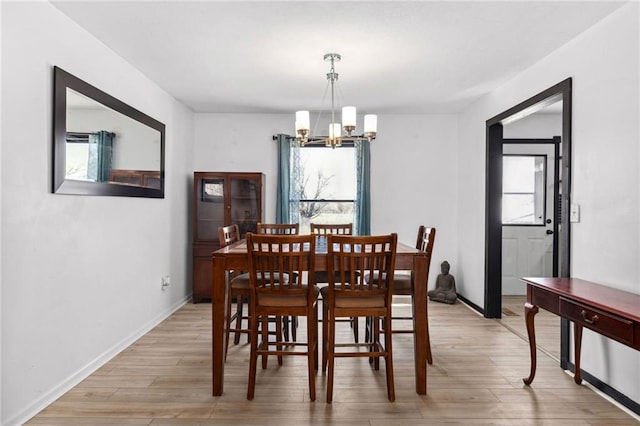 17259 174th St, Basehor, KS 66007 - dining area with a chandelier, light wood-style flooring, and baseboards