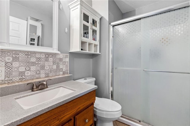 17259 174th St, Basehor, KS 66007 - full bathroom with toilet, a stall shower, tasteful backsplash, and vanity