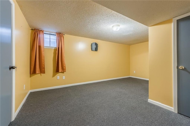 carpeted spare room with baseboards and a textured ceiling