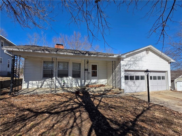 ranch-style home featuring a garage, concrete driveway, covered porch, and a chimney