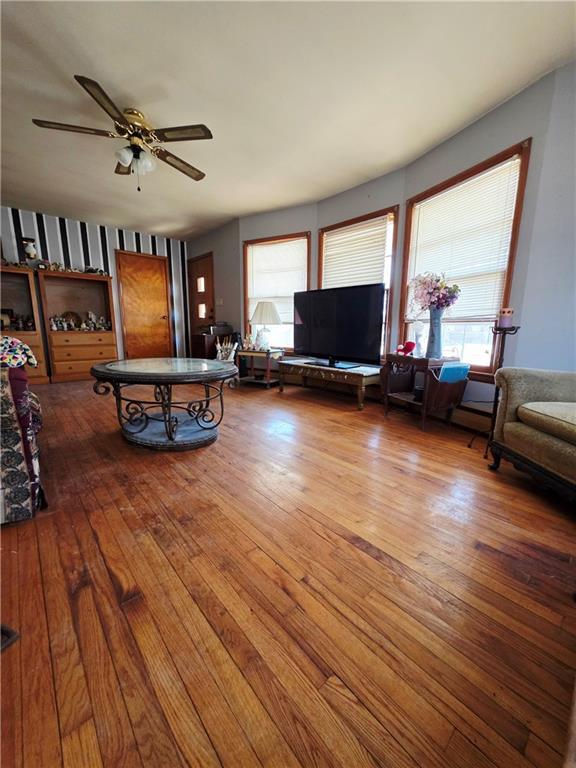 living area featuring ceiling fan and hardwood / wood-style floors