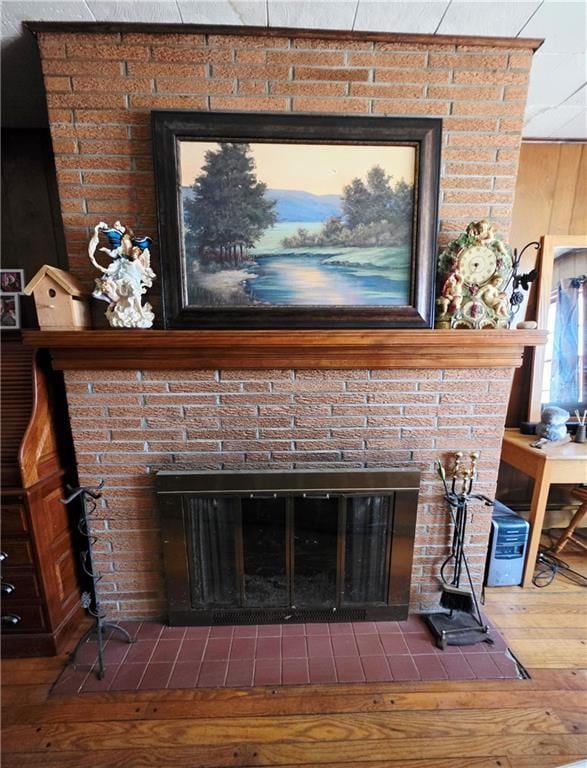 room details featuring a fireplace and wood finished floors