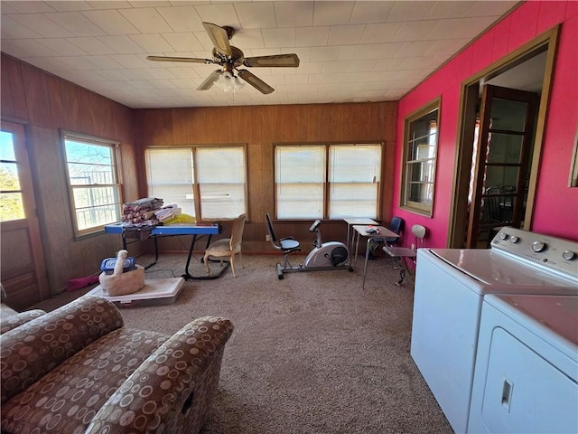 sunroom / solarium with washing machine and clothes dryer and a ceiling fan