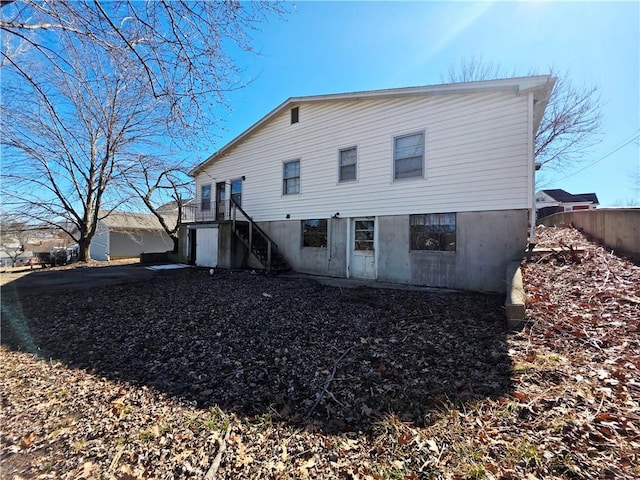 rear view of house featuring stairway