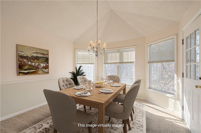 carpeted dining room featuring lofted ceiling, a textured ceiling, baseboards, and a notable chandelier